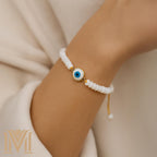 Mana Gallery Handmade Evil Eye Bracelet – White Mother of Pearl Beads with Gold-Plated Blue Eye Charm – Adjustable Macramé Cord – Protective Jewelry Gift for Women (Evil Eye Bracelet)